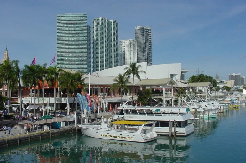 many boats are docked next to a boardwalk