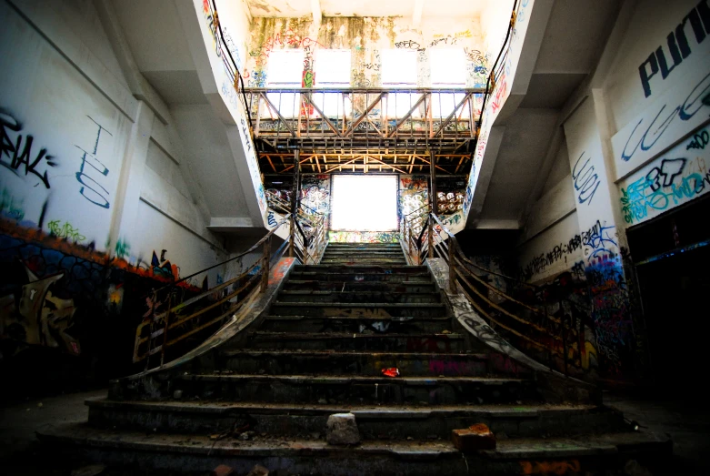 the stairway has many graffiti all over it