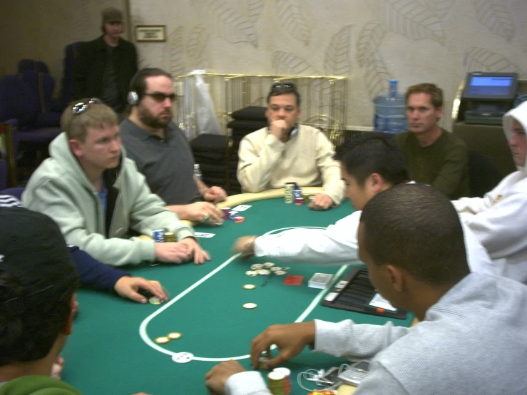 a group of men playing blackjack in a gambling room