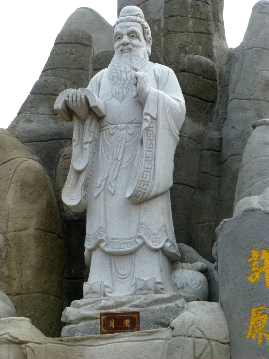 a statue of a bearded monk holding a staff