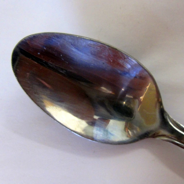 a spoon that has some kind of blue and brown substance on it