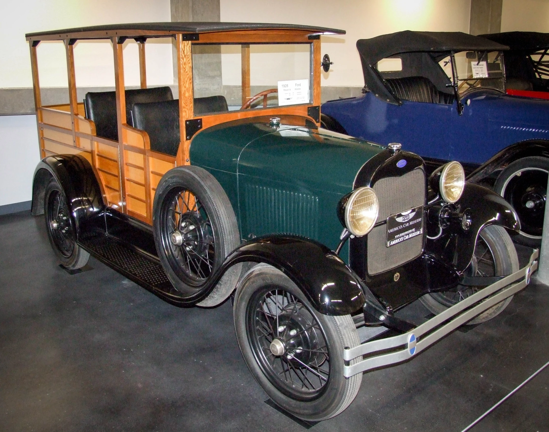 an old fashioned car is on display at a museum
