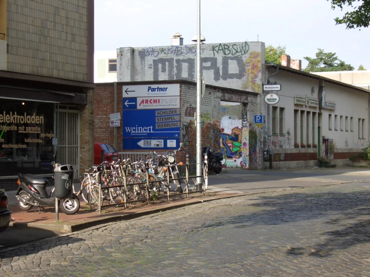 many bicycles parked up next to each other on a city street