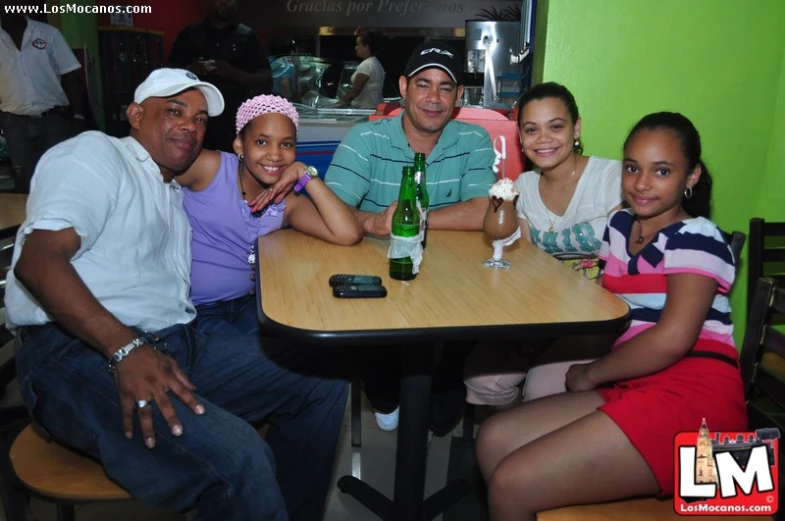 a group of people smiling at a table