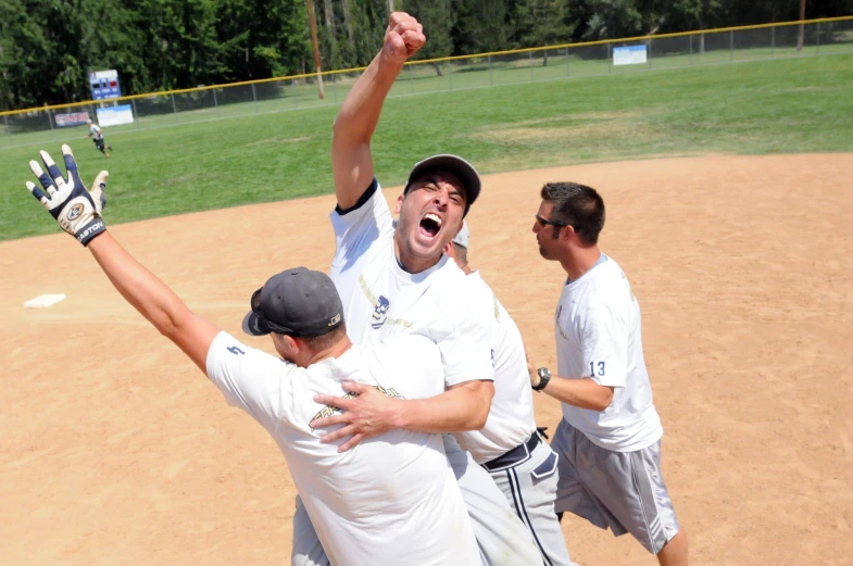 a baseball player is mobbing the opposing players while one of them celetes