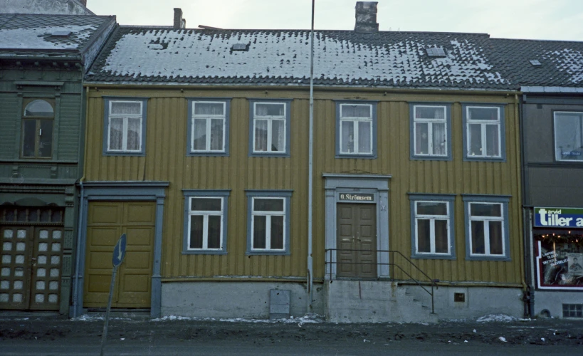 some old looking buildings with snow on them