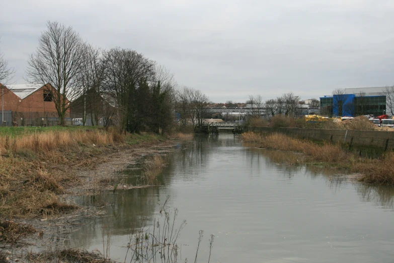 the river is quiet with a bridge in the distance