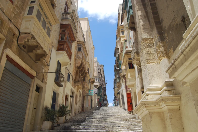 a view from the bottom of some street with stone buildings