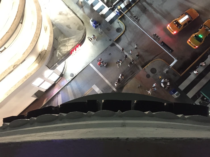 an aerial view looking down at street and taxi cabs