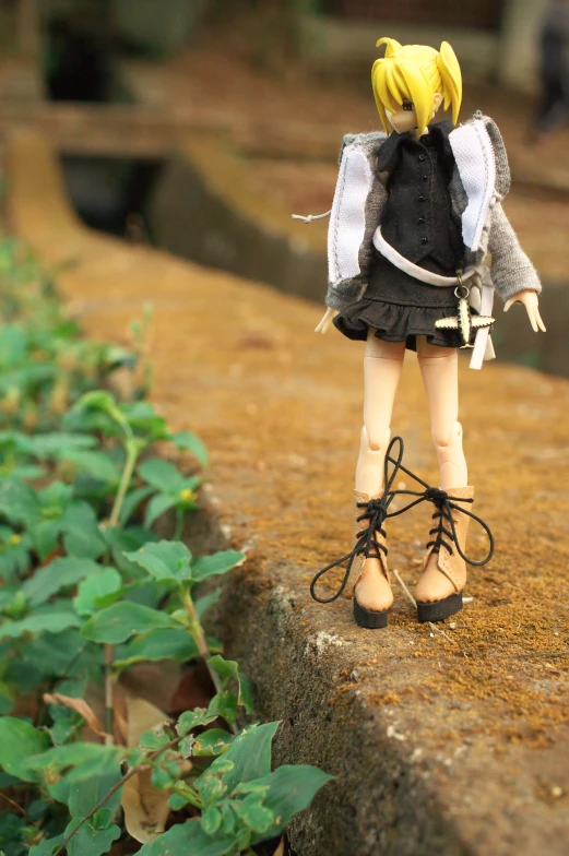 there is a doll that looks like she is walking on some rocks