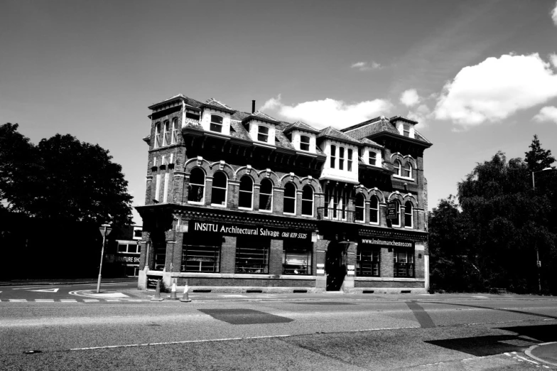 a large old building on the corner of a road