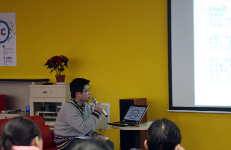 a man standing in front of a projection screen