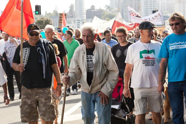 people walking in line with flags and signs