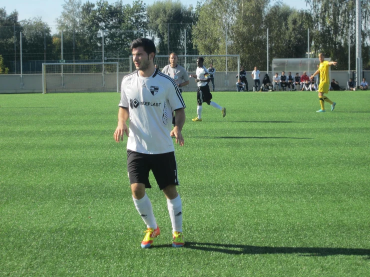 a group of men playing soccer on a field