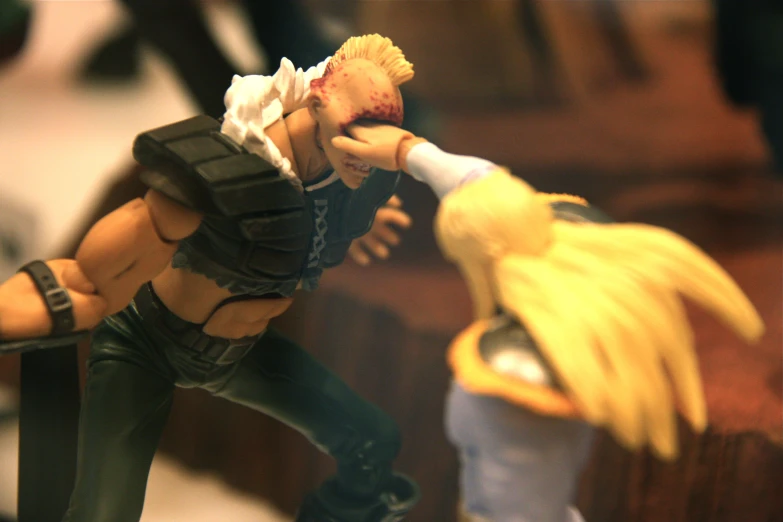 two anime figurines are fighting each other