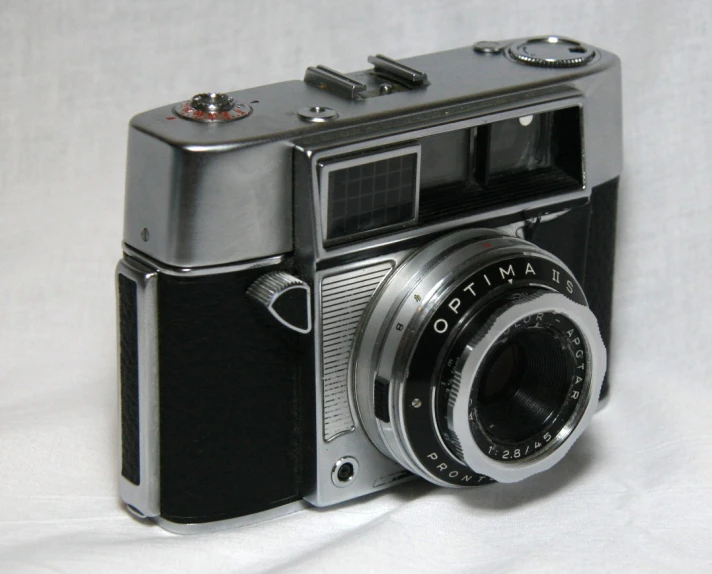 an old camera with an lens attached on a white background