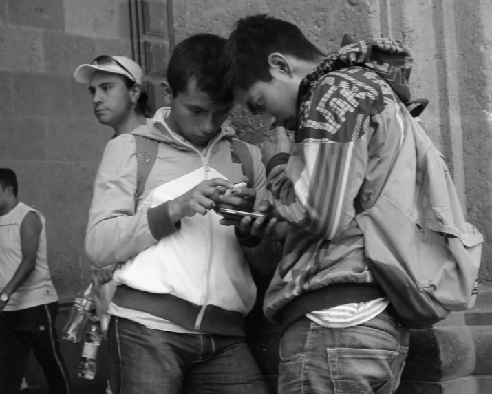 a black and white po of young people standing in the street