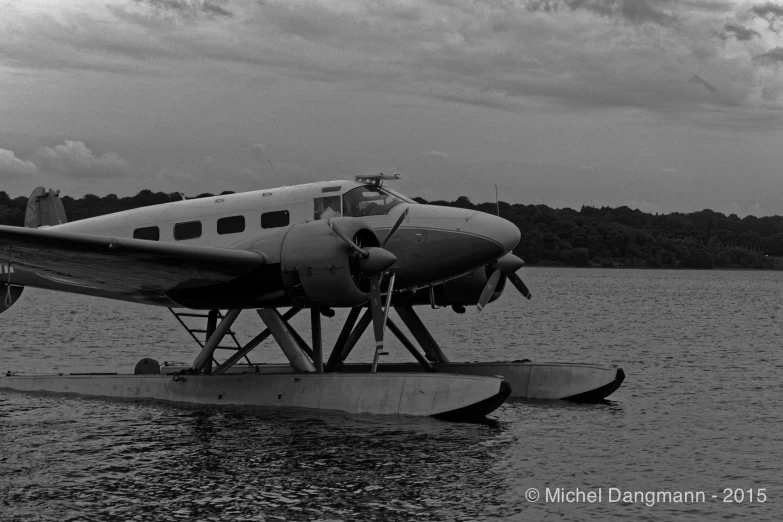 a small airplane in the water getting ready to land