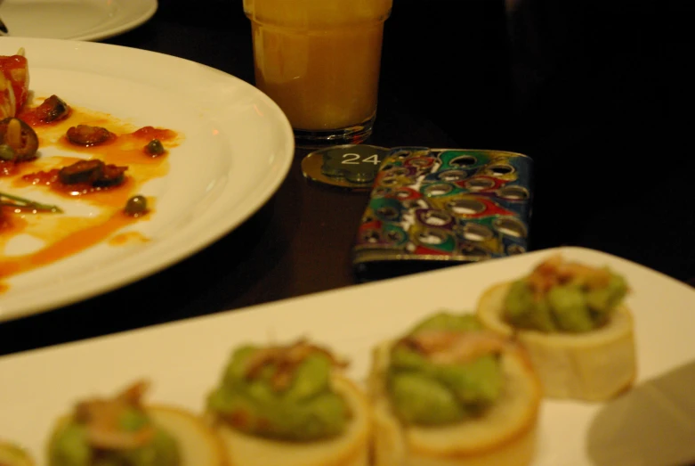 an assortment of desserts with guacamole in a plate