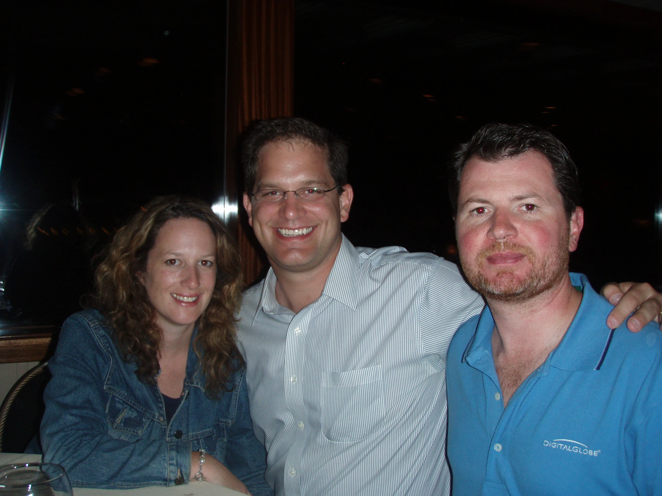 two people are posing for a picture with a man