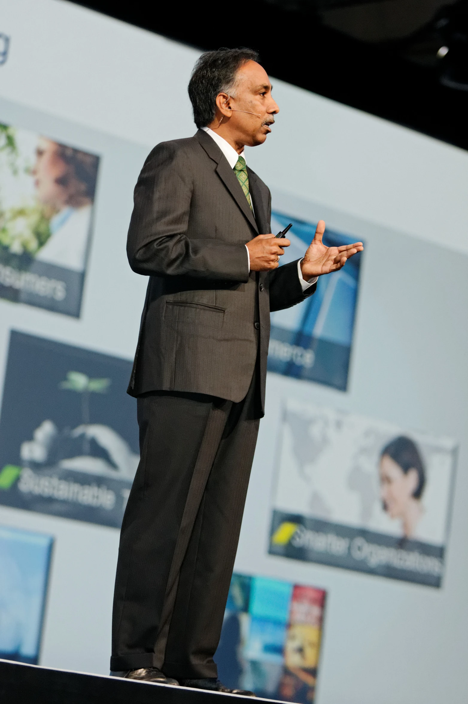 a man standing on top of a stage giving a speech