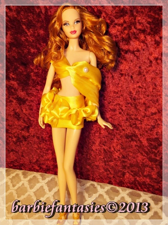 a red and yellow barbie doll with long hair