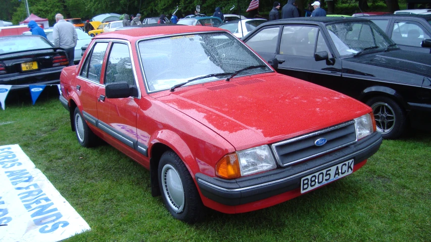 a red car is parked in an antique show