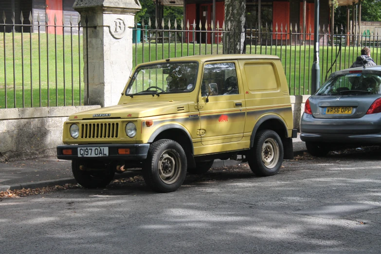 a yellow truck parked by itself on a street