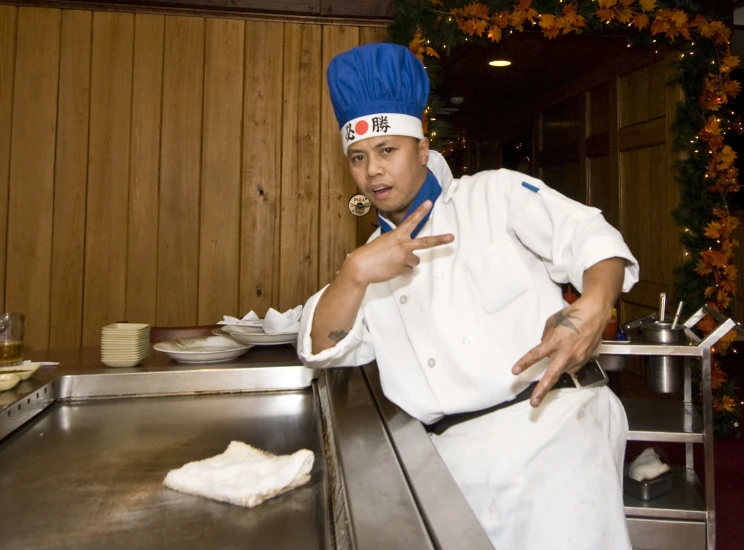 man in a chef uniform posing for the camera
