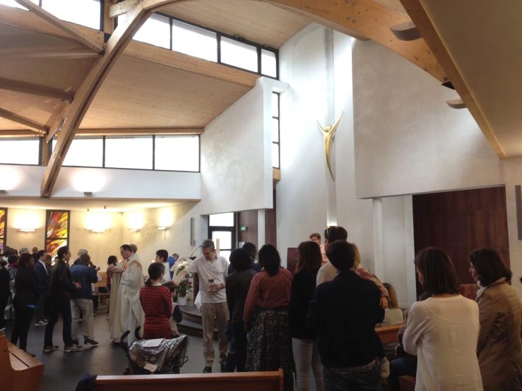 people standing around in a room with an open roof