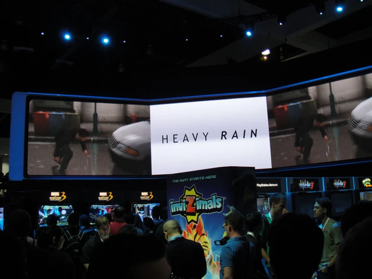 a large screen in the middle of a room that says heavy rain