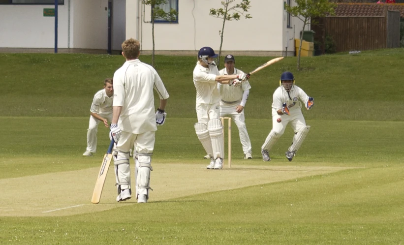 a group of men playing a game of cricket