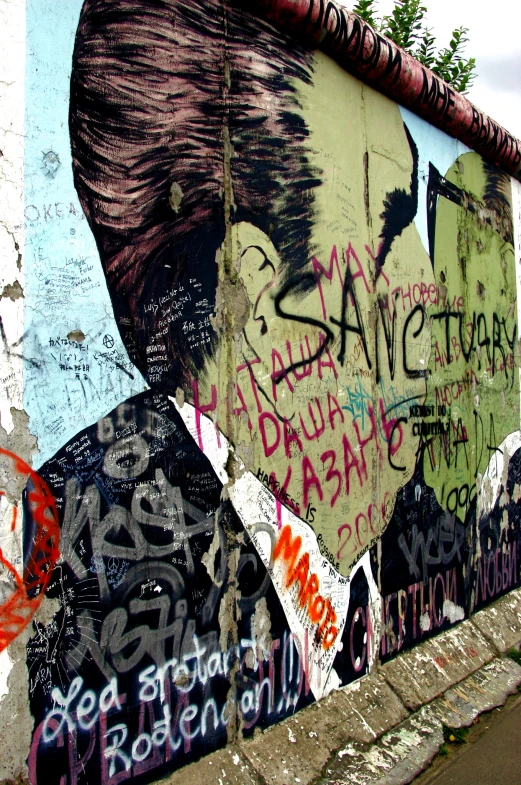 a person standing in front of graffiti on the wall