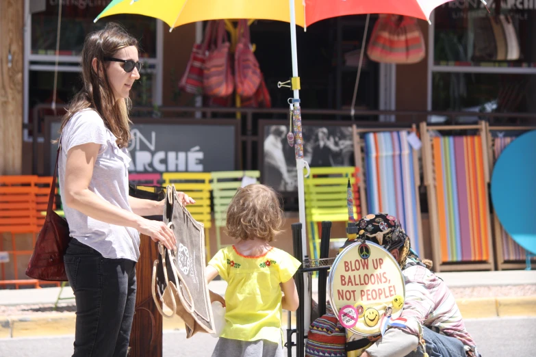 an adult and child on a city street