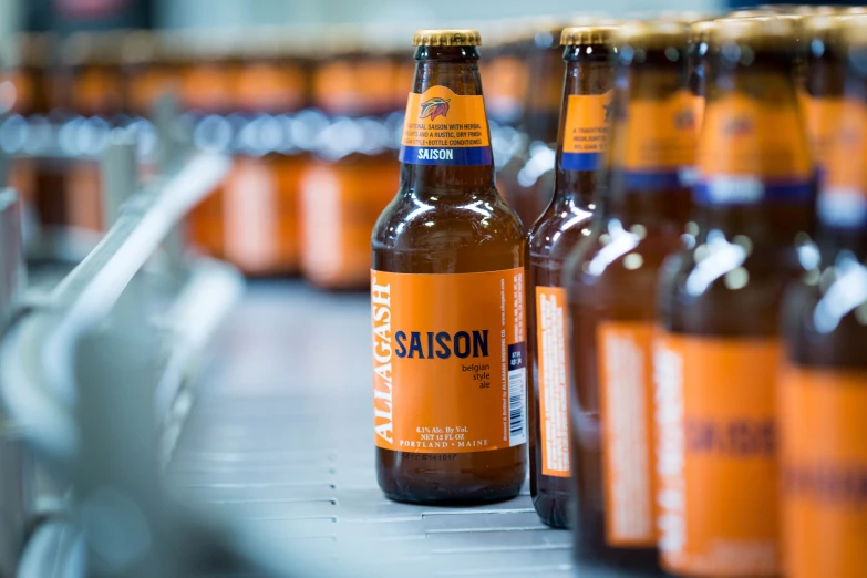 an image of a bottle of beer on a conveyor belt