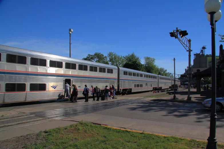 group of people walking around a parked train