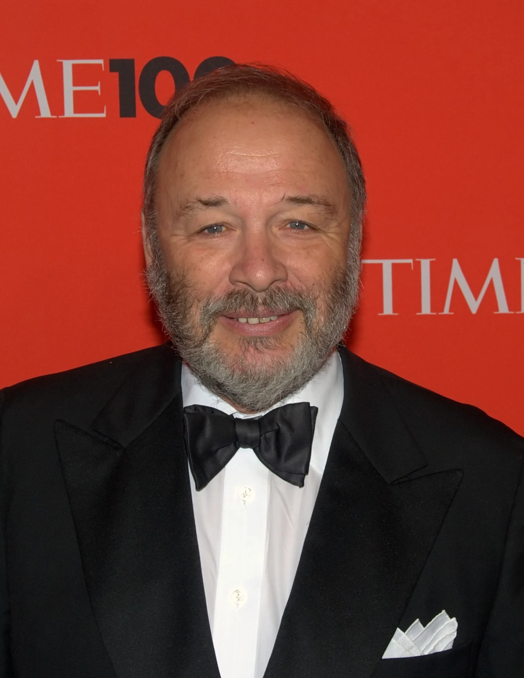 an older man with beard wearing a tuxedo