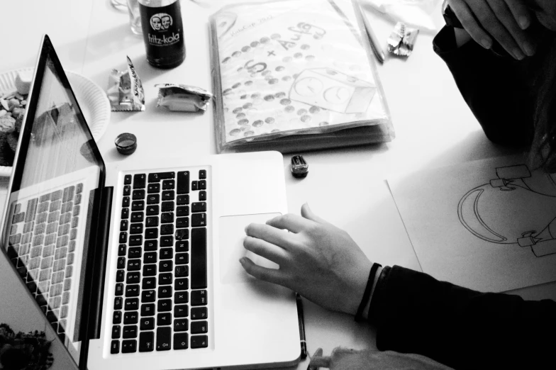 people working on an office work station with a laptop computer and mouse