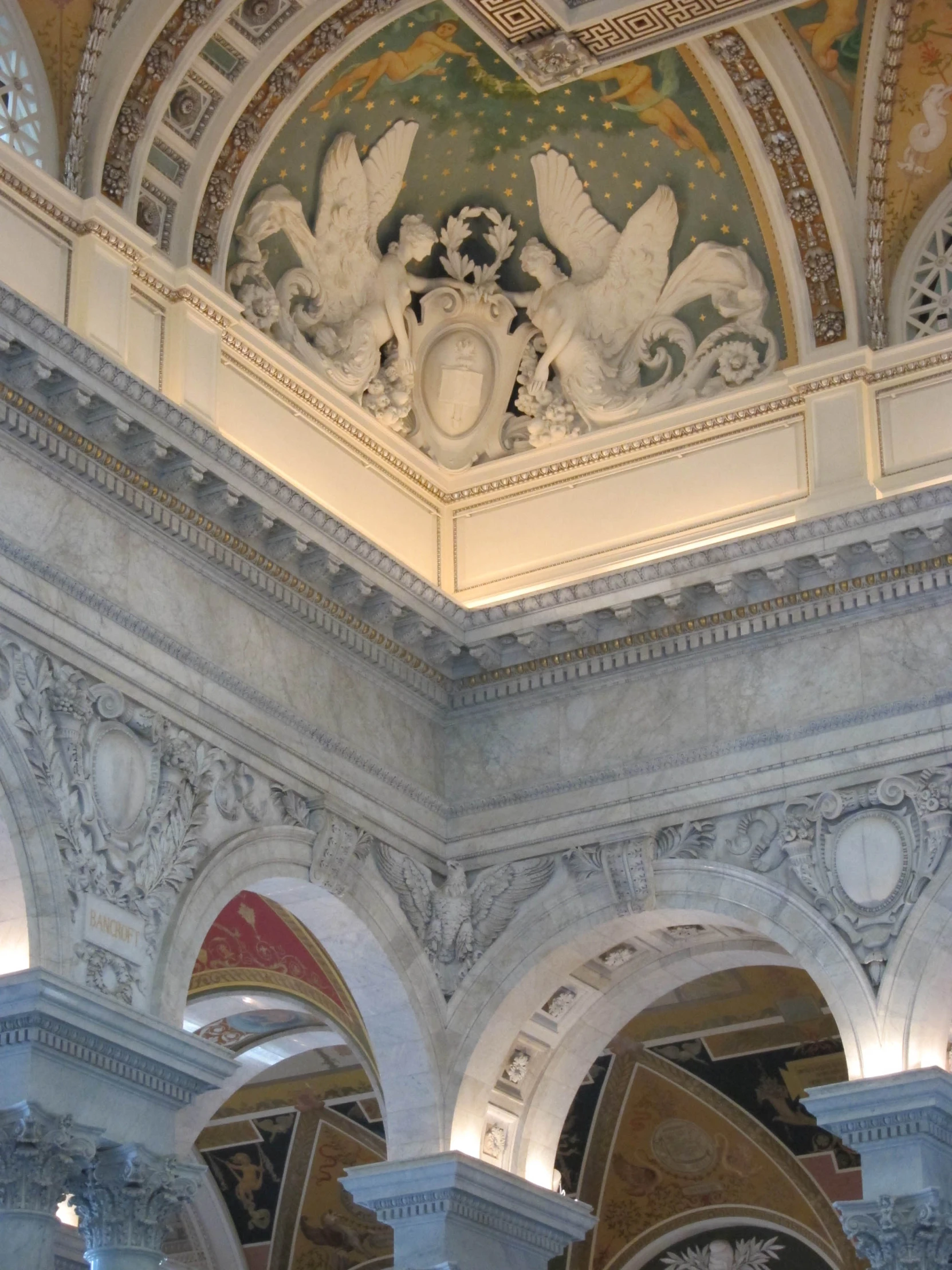 an intricate ceiling in the lobby of a business building