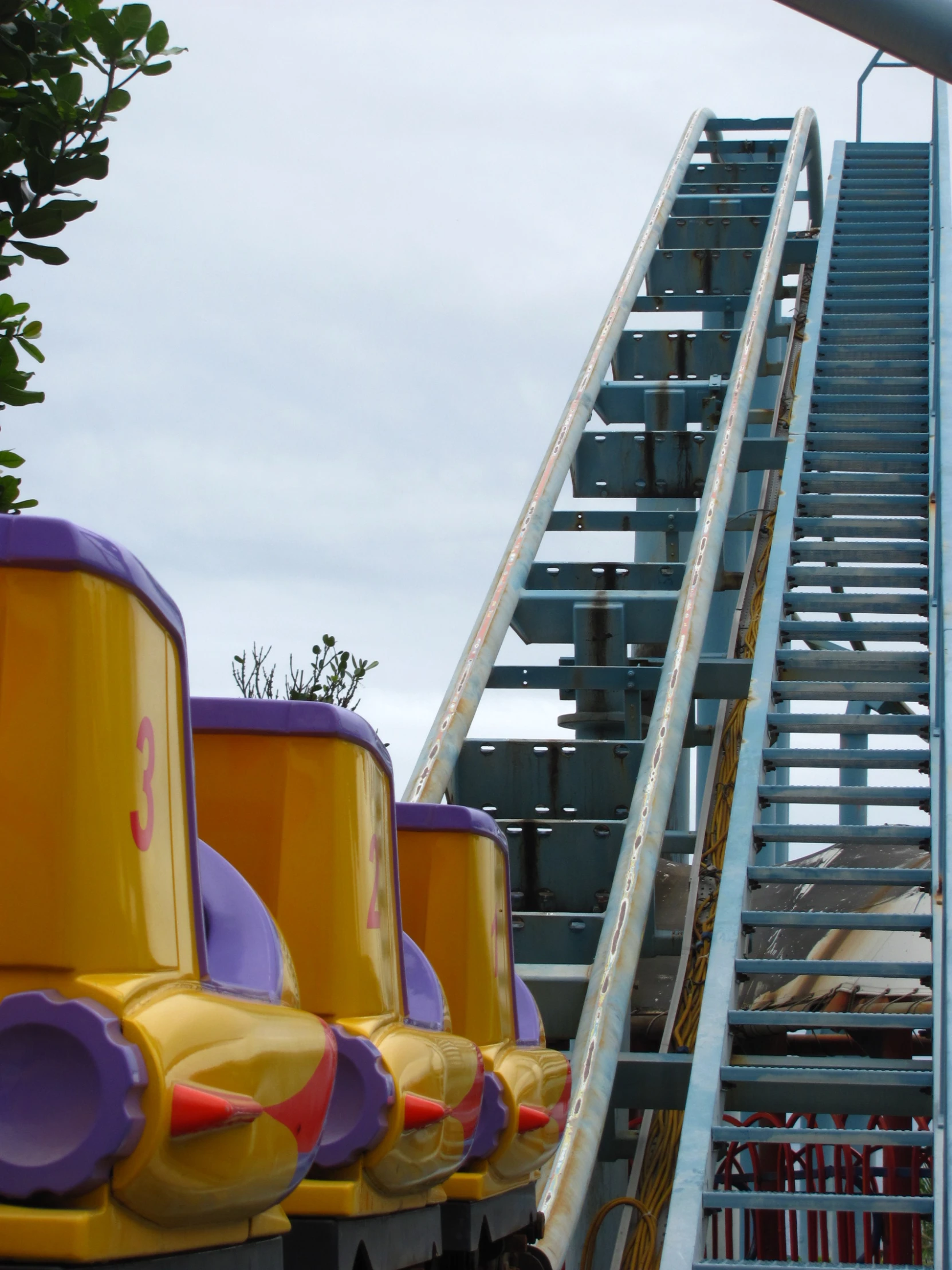 a large roller coaster with lots of purple and yellow decorations