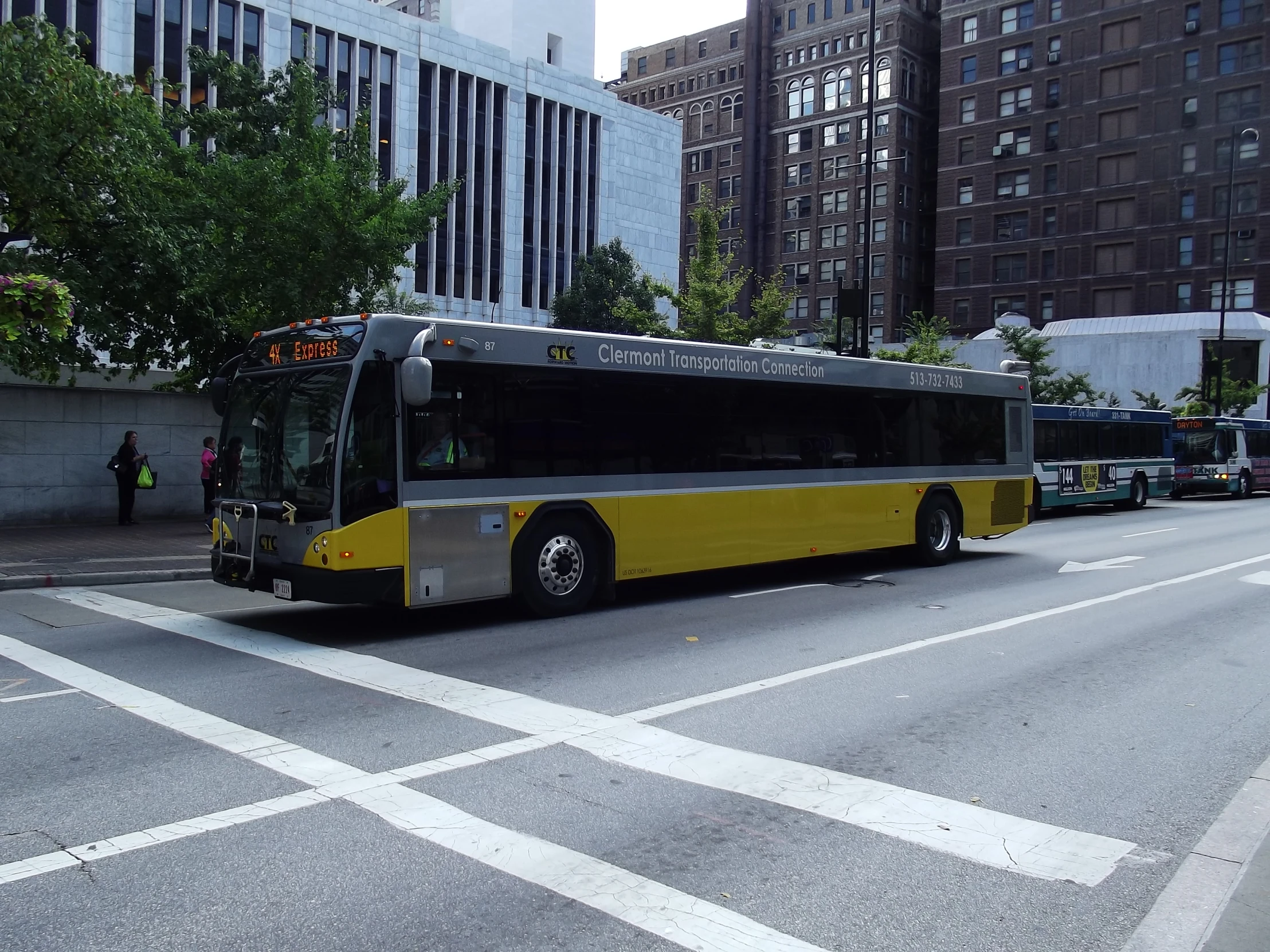 a city bus at an intersection in a big city