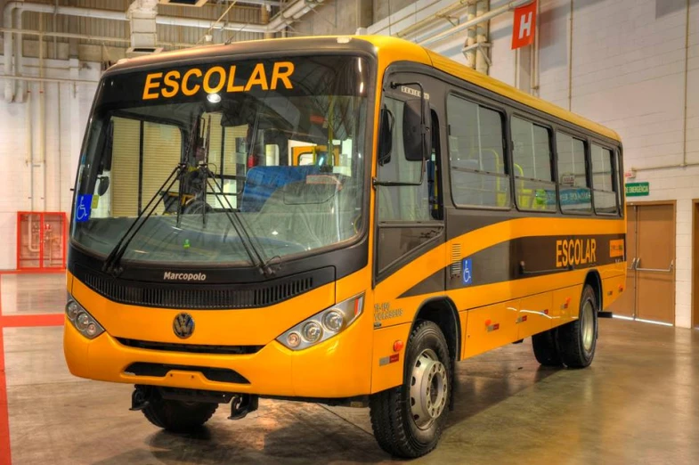 a very bright yellow bus in a warehouse
