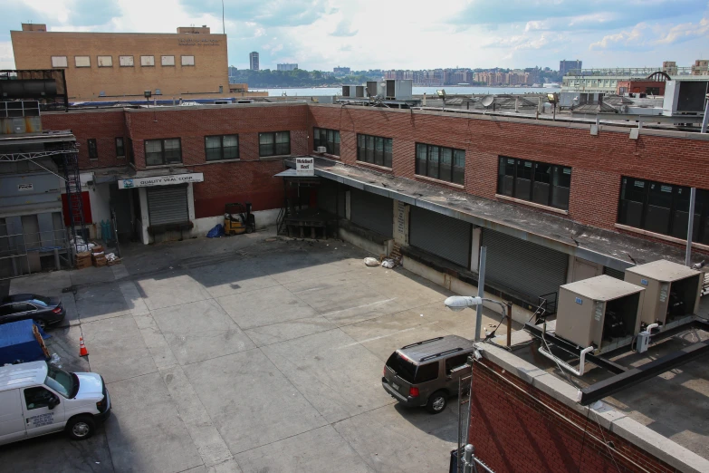 an aerial view of some buildings and water with a truck in the center