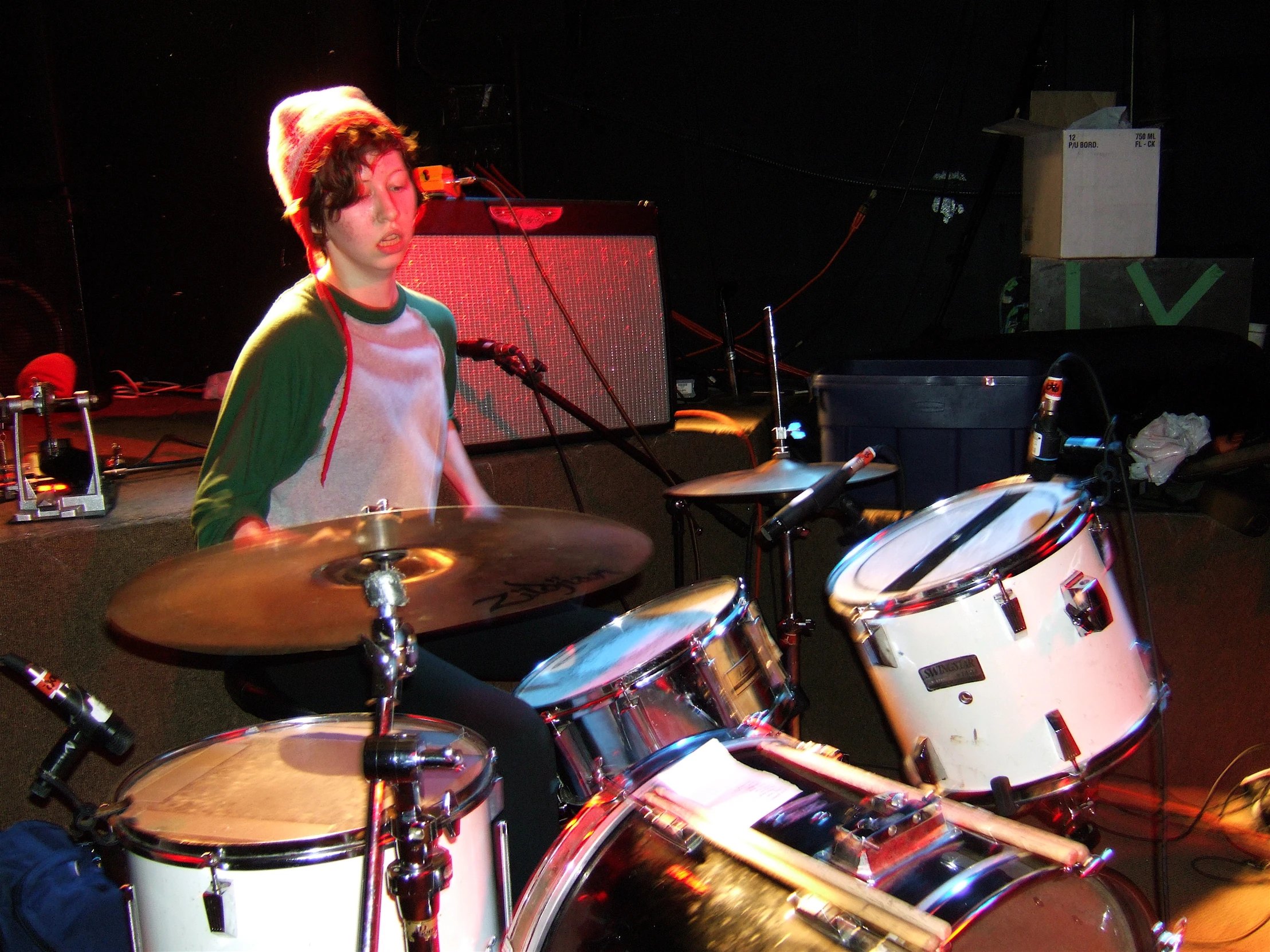 a man playing the drums on a stage