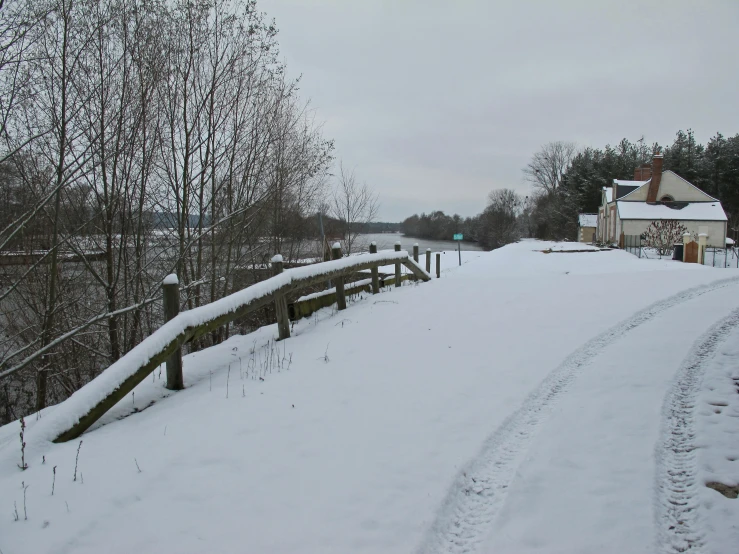 snow covered path going to a home on the other side