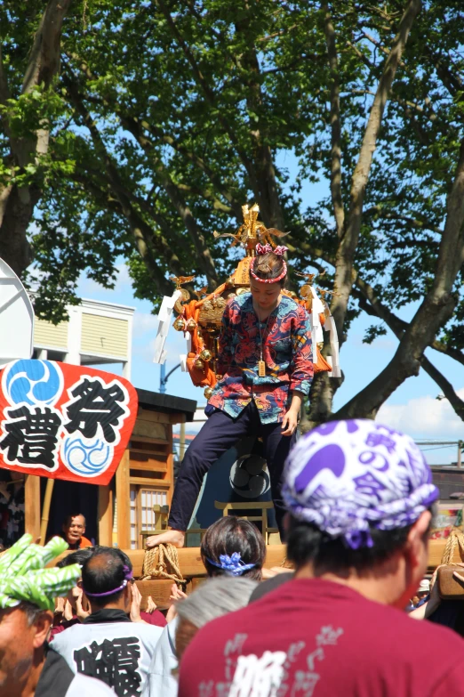 a man on stage holding soing with his hands