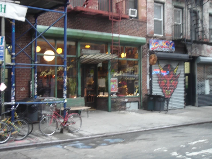 a street side store with scaffolding and bike parked next to it