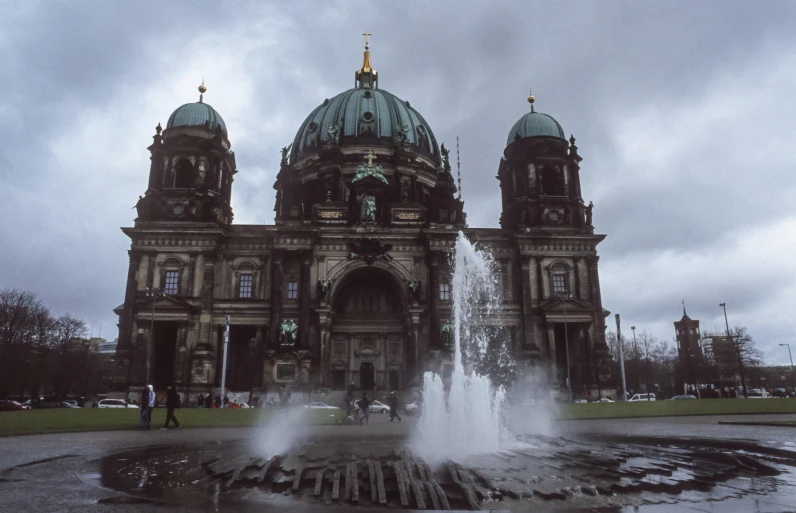 a fountain is in front of an old building