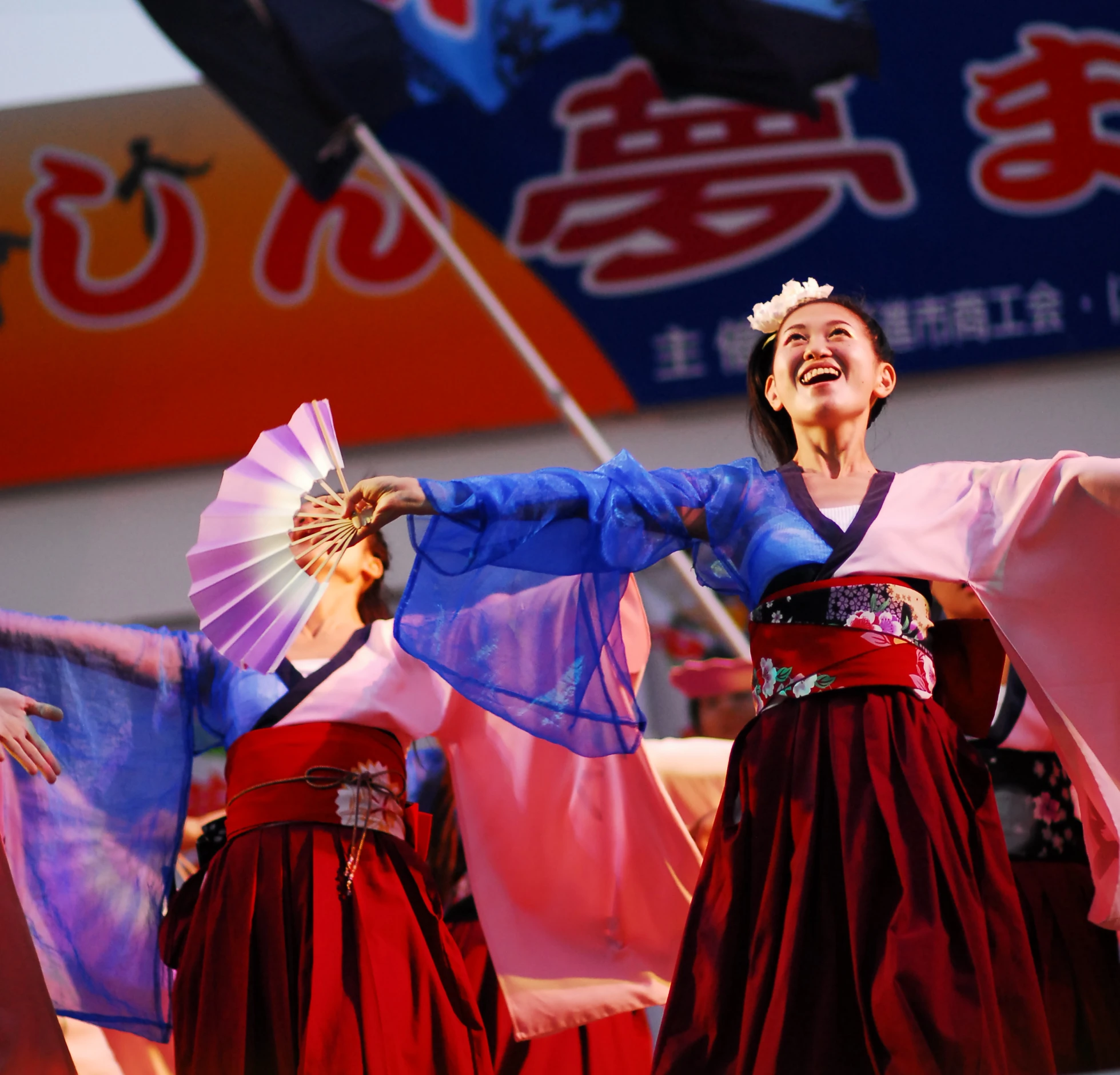 two woman standing next to each other in colorful clothing