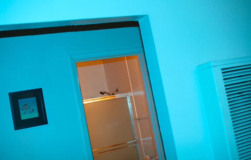 a refrigerator sitting inside of a blue kitchen